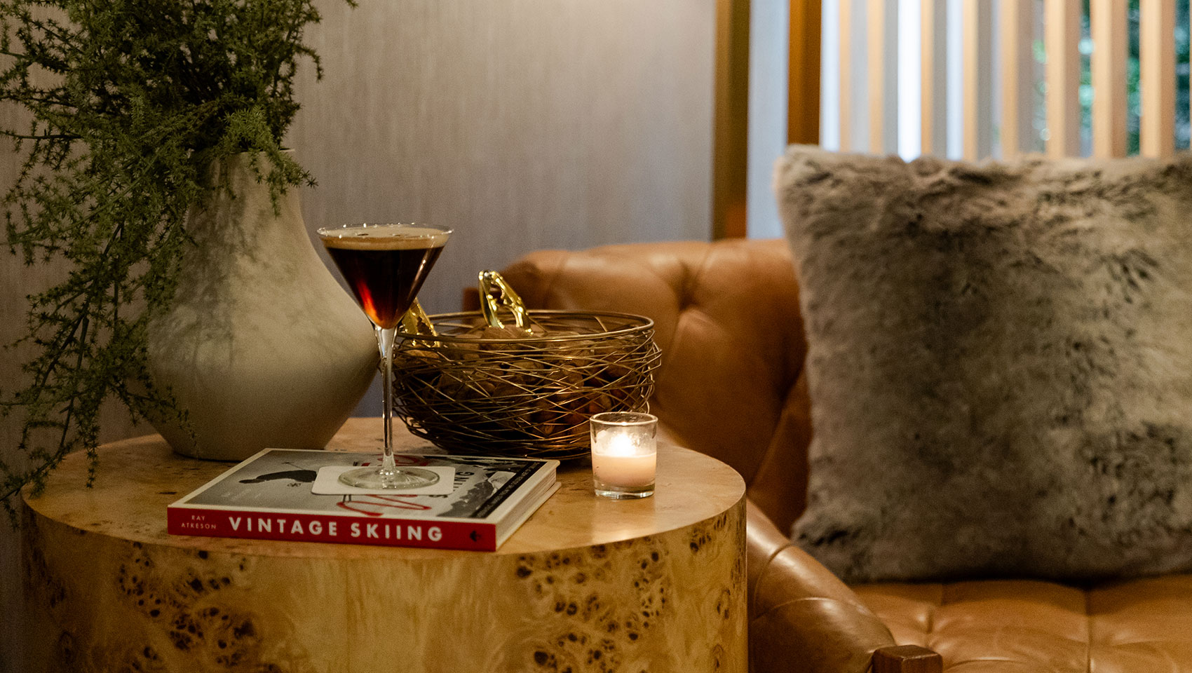 Chalet side table with cocktail, book, plnat and candle