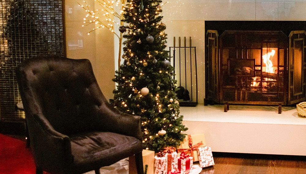 Holiday tree by a fireplace