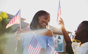 mom and son holding american flags